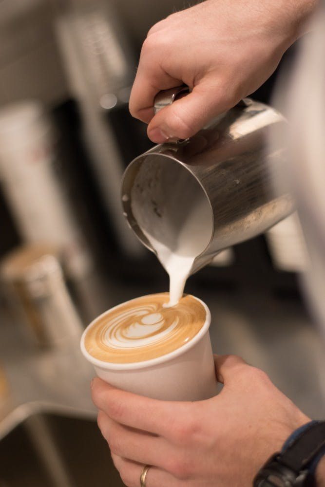 Barista Jake Mcfarland puts the finishing touches on a cup of coffee on Monday, March 19, 2018, in Auburn, Ala.