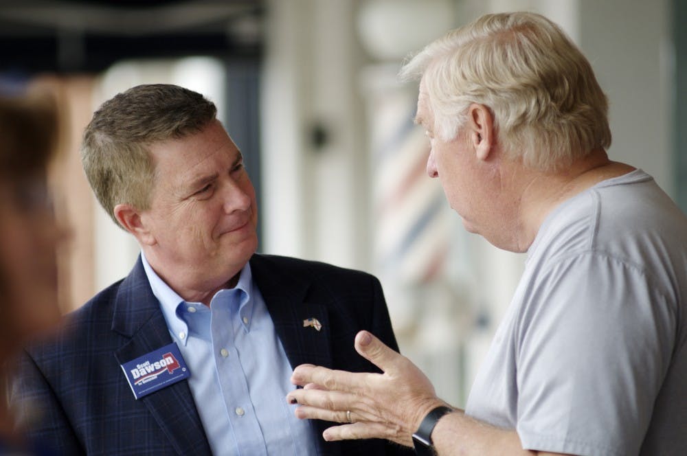 <p>Alabama governor candidate&nbsp;Scott Dawson speaks with a&nbsp;member of the Auburn community at Toomer's Corner on Thursday, May 31, 2018 in Auburn, Ala.</p>