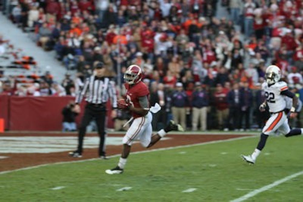 Alabama receiver Amari Cooper hauls in one of his two first half touchdown receptions in the Crimson Tide's 49-0 Iron Bowl rout of Auburn. (Danielle Lowe / ASSISTANT PHOTO EDITOR)