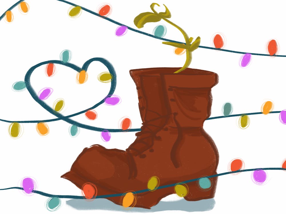 A green plant grows inside an old dirty boot, and the scene is surrounded by bright, colorful string lights.