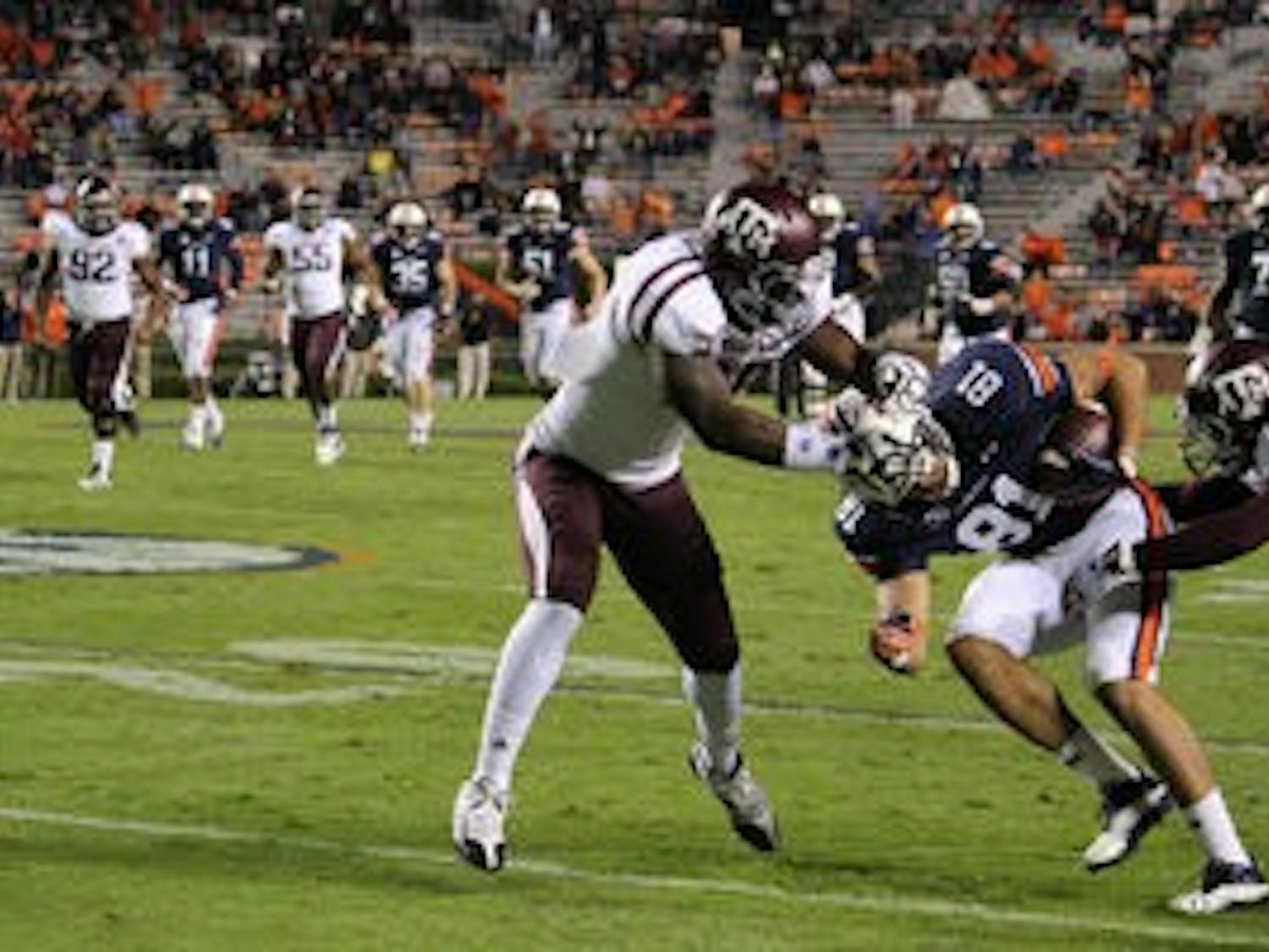 Wide receiver C.J. Uzomah is tackled by the Texas A&M defense. (Rebecca Croomes / PHOTO EDITOR)