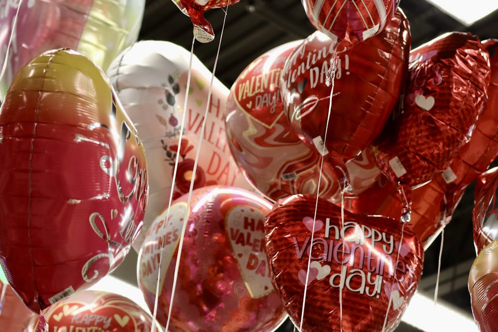 <p>Valentine's Day balloons float above the shelves at a local grocery store on Feb. 12, 2023.</p>