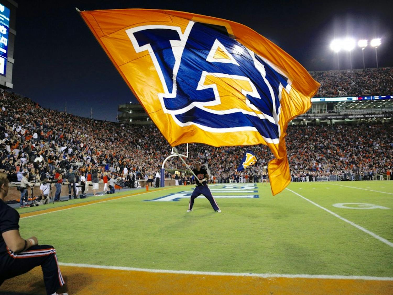 Trenton White waves the flag after Auburn scores a touchdown in Jordan-Hare Stadium on Oct. 22, 2016.