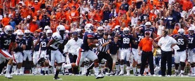 Auburn fans cheer as freshman running back Tre Mason sprints past Utah State defenders for a 97-yard kickoff return for a touchdown in the second quarter Saturday. (Robert E. Lee / ASSISTANT CAMPUS EDITOR)