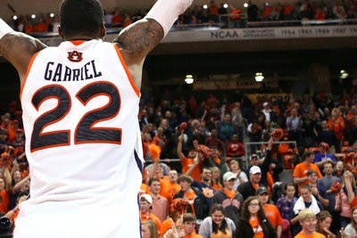 Senior forward Kenny Gabriel celebrates Auburn's 67-52 win against LSU with the student section of Auburn Arena, known as The Jungle. The final home game for the 2011-12 season also marks Gabriel's last season as an Auburn student; he graduates in May with a degree in sociology. (Rebecca Croomes / PHOTO EDITOR)