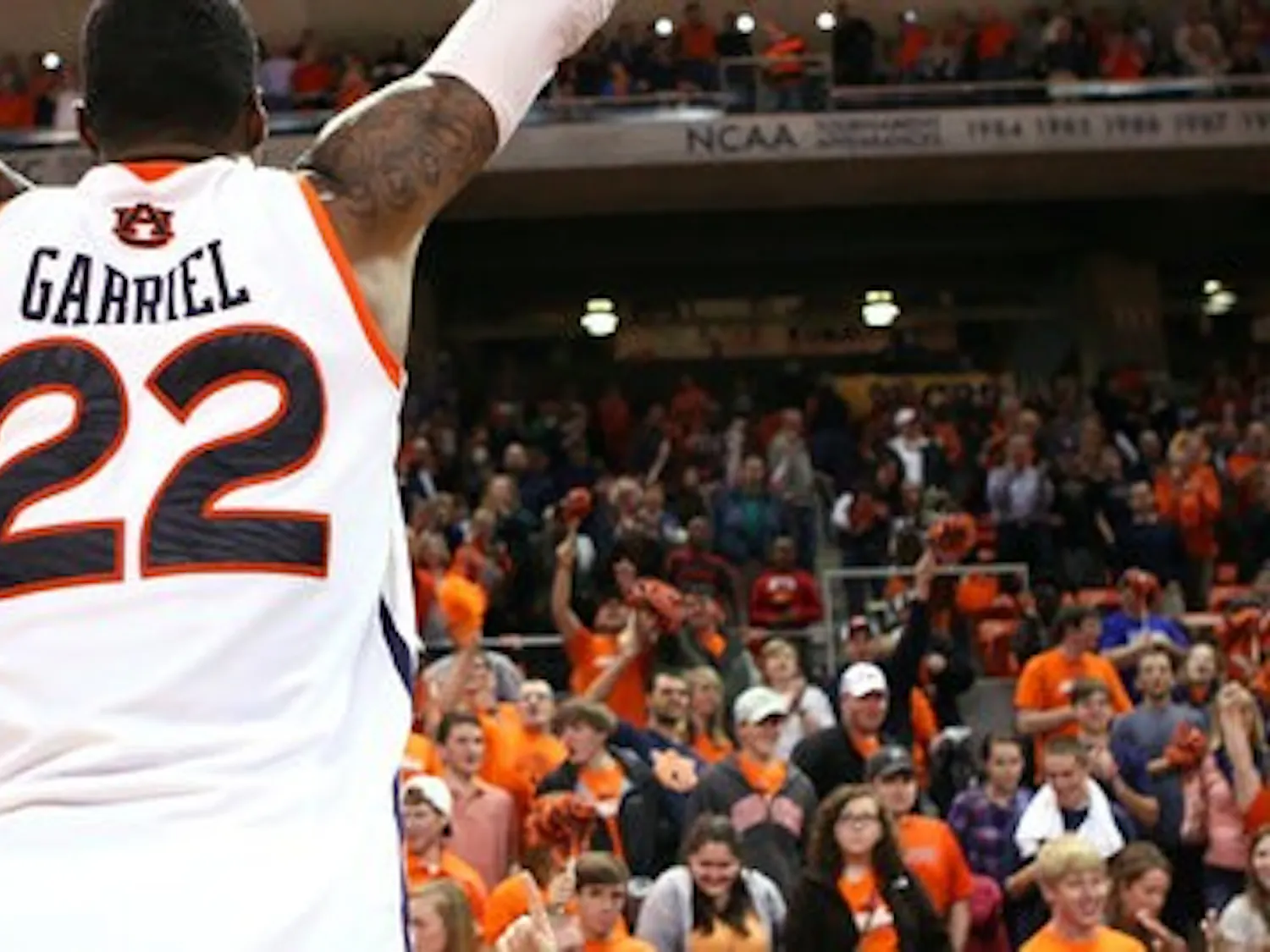 Senior forward Kenny Gabriel celebrates Auburn's 67-52 win against LSU with the student section of Auburn Arena, known as The Jungle. The final home game for the 2011-12 season also marks Gabriel's last season as an Auburn student; he graduates in May with a degree in sociology. (Rebecca Croomes / PHOTO EDITOR)
