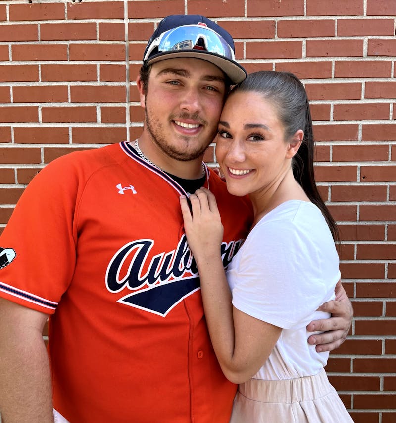 Sonny DiChiara and Gabrielle Cerasoli pose together at Plainsman Park after an Auburn baseball game. 
