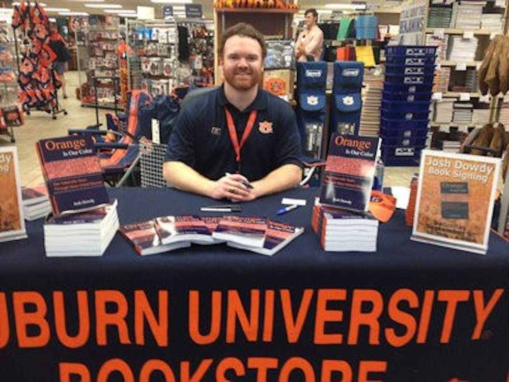 Auburn alumnus Josh Dowdy signs copies of his new book, Orange Is Our Color. (Contributed by Auburn University Bookstore)