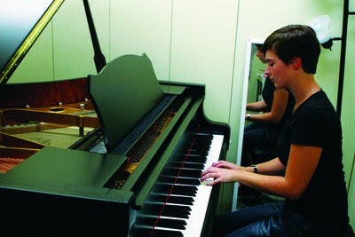 Julia Tucker, junior in piano performance and economics, hones her skills on one of the new pianos in a practice room at Goodwin Hall. (Rebecca Croomes / ASSISTANT PHOTO EDITOR)