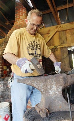 Earl Bryant of Valley, an apprentice blacksmith, makes a fireplace poker at the Battle of Loachapoka Saturday. (Emily Adams / PHOTO EDITOR )