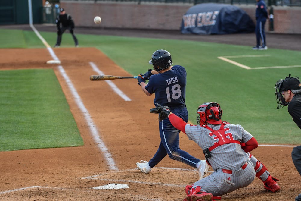 Auburn designated hitter Ike Irish (18) hits a pop-up foul ball in the home opener against Indiana in Plainsman Park on Feb. 17, 2023.