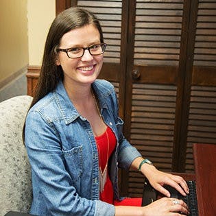 Tori Rivers, senior in public relations, works at her desk in the Office of Communication and Marketing.