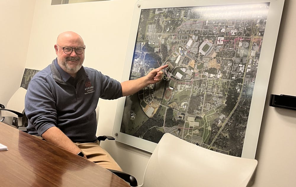 <p>University Architect Simon Yendle points to a layout map of Auburn's campus in his office in the Facilities Management building..</p>