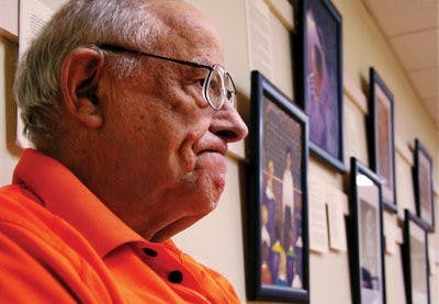Henry Stern, a Holocaust survivor and Opelika resident, sits at the "Darkness into Life" art exhibit in Opelika Thursday. (Rebekah Weaver / Assistant Photo Editor)