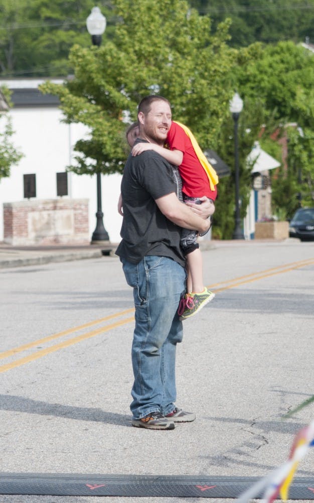 Abbigayle and Nather Armstrong&nbsp;embrace after finishing the 5k&nbsp;at the 2016 Superhero Opelika 5k on Saturday, Apr., 30 in Opelika Ala.
