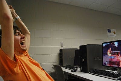 Brett Bayley enjoys a victory in TF2 at the Computer Gaming Club meeting Friday night. He and his peers have a passion for socializing over video games. (Tim Simpson / Photo Staff)