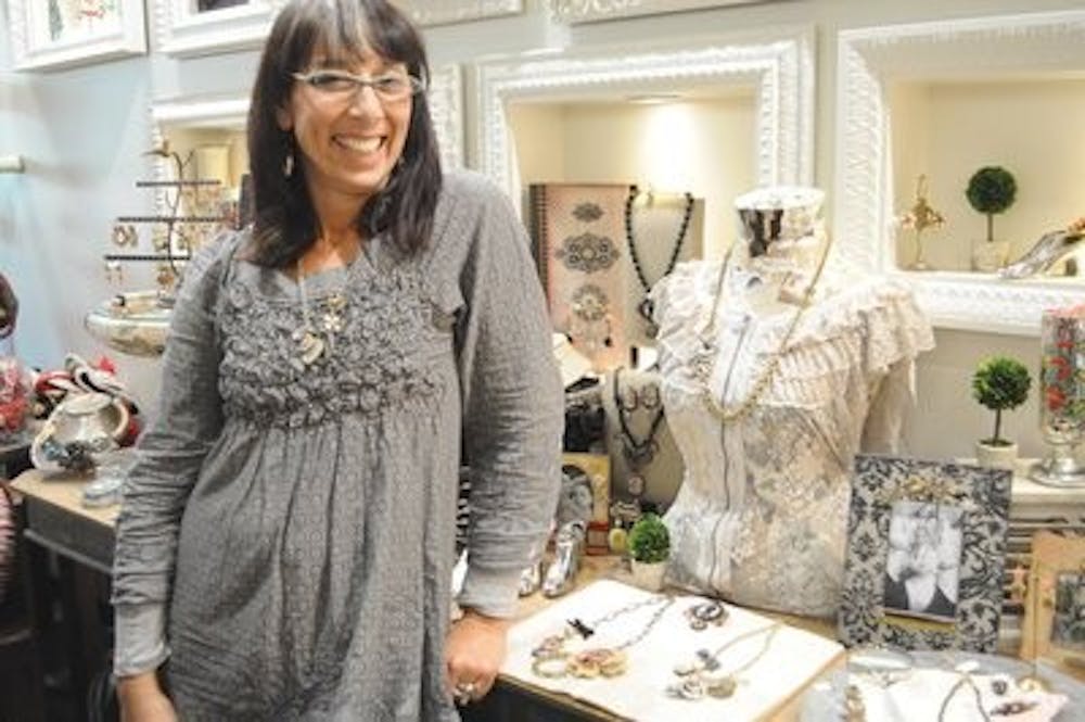 Jewelry designer Jill Schwartz stands by some of her pieces being showcased at The Villager Nov. 1. (Christen Harned / Assistant Photo Editor)