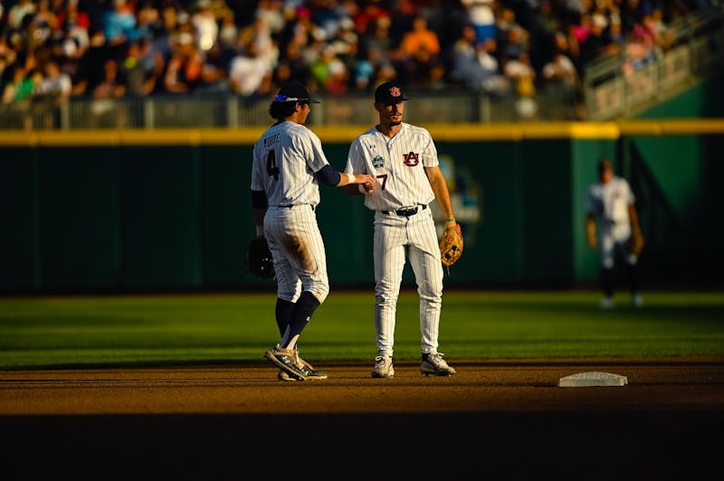 Shortstop Brody Moore and second baseman Cole Foster convene during the game versus Arkansas in Omaha.