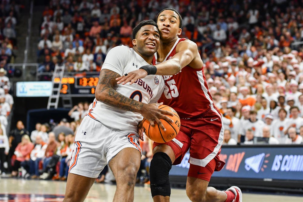 <p>Auburn guard K.D. Johnson (0) pushes to score in a matchup against Alabama in Neville Arena on Feb. 11, 2023.</p>