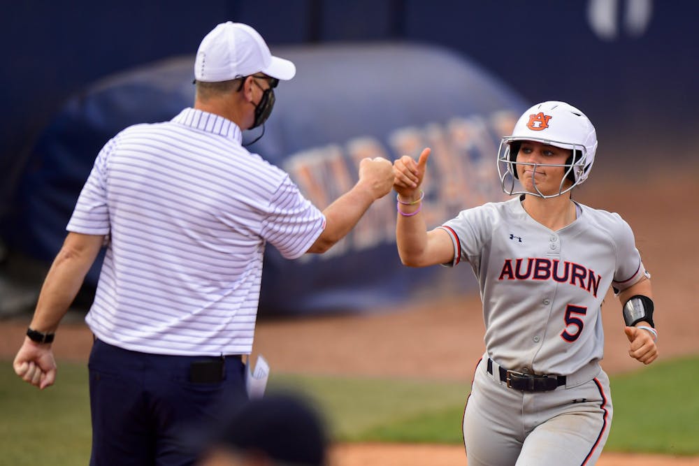 Apr 13, 2021; Auburn, AL, USA; Auburn Tigers Lindsey Garcia (5) greets Mickey Dean after she hits a home run during the game between Auburn and Alabama State at Jane B. Moore Field. Mandatory Credit: Shanna Lockwood/AU Athletics
