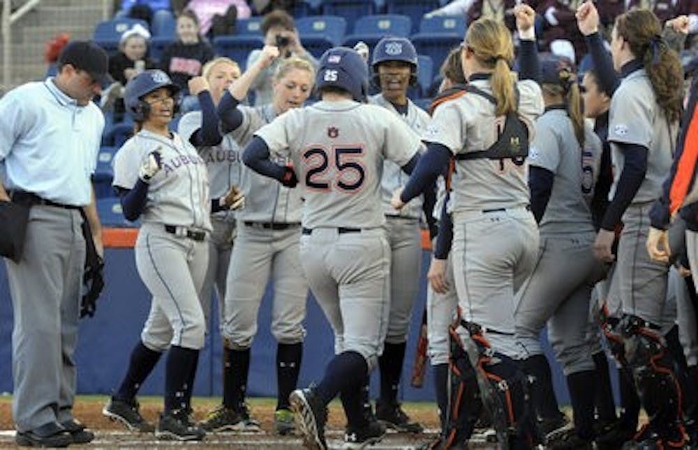 Auburn's McKenzie Kilpatrick is greeted at home after hitting a homerun in the first inning against Morehead State on Saturday, February 8, 2014. (Contributed by Anthony Hall)