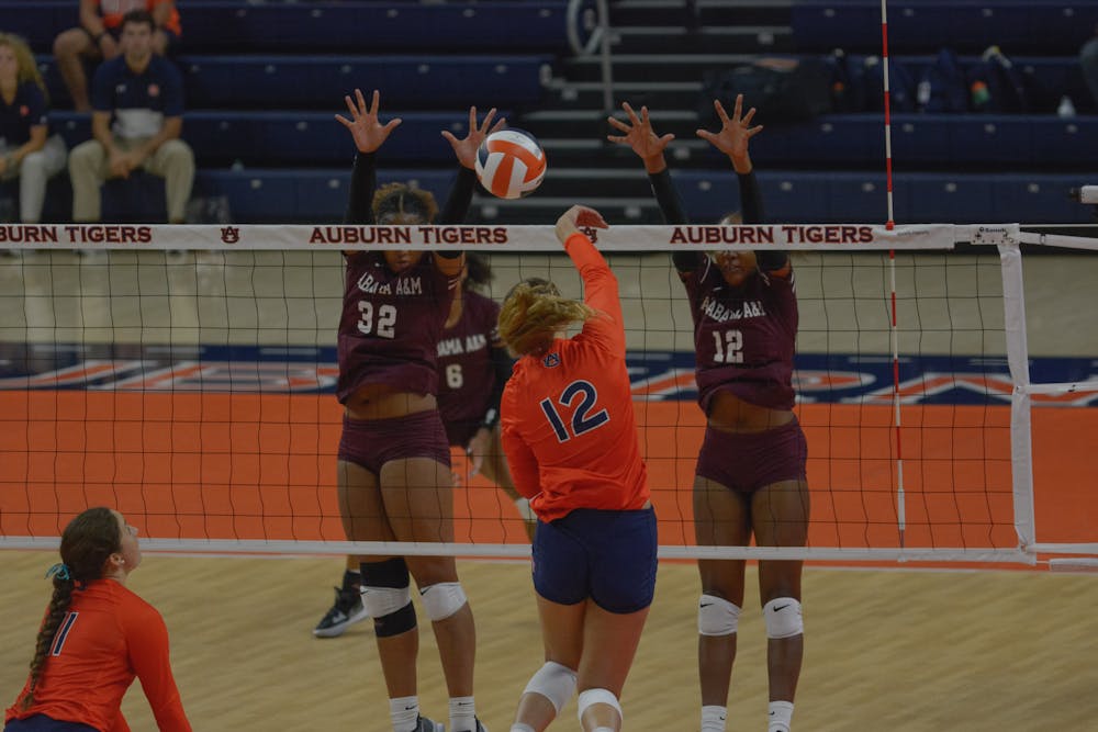 <p>Bell Zimmerman (#12) spikes the ball in a match between Auburn and Alabama A&amp;M at Neville Arena on Sep. 6, 2022.</p>