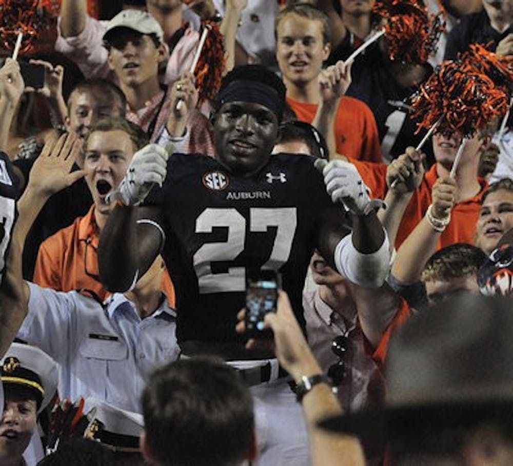 Therezie celebrates in the student section after last year's victory over Ole Miss, in which he had a pick-six interception. (File Photo)