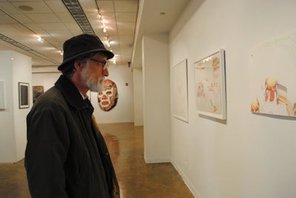 Tom Manig, philosophy instructor, views the "Drawing on Alabama" exhibit. The exhibit will be on display through Feb. 4. (Maria Iampietro / Associate Photo Editor)