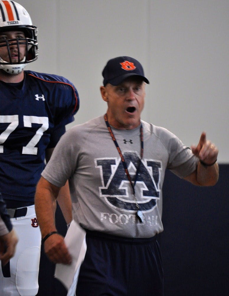 Offensive line coach J.B. Grimes goes over blocking schemes with his players before practice.Anna Grafton / ASSOCIATE PHOTO EDITOR