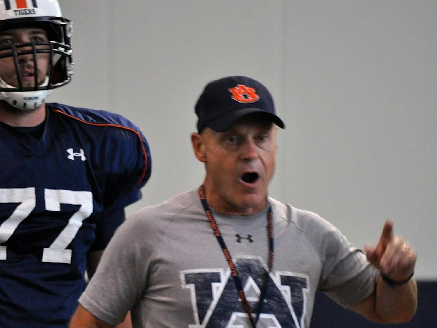Offensive line coach J.B. Grimes goes over blocking schemes with his players before practice.Anna Grafton / ASSOCIATE PHOTO EDITOR