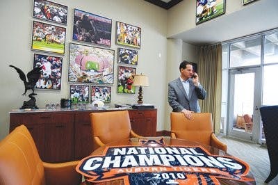 Gene Chizik phones recruits on National Signing Day. (Todd Van Emst / MEDIA RELATIONS)