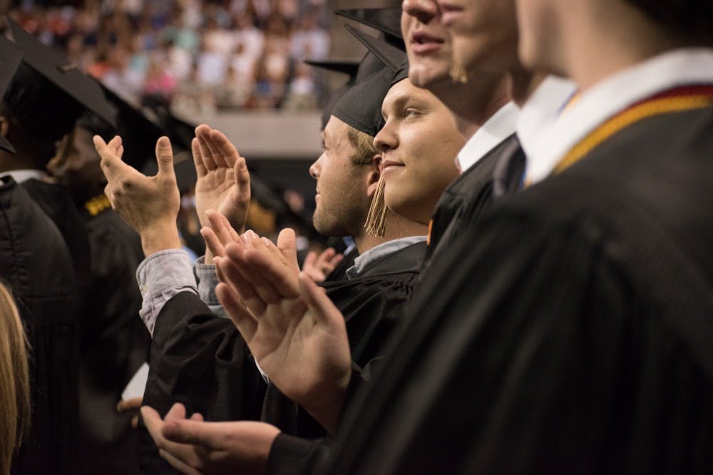 The graduates clap at the graduation ceremony on Sunday, May 6, 2018, in Auburn, Ala.