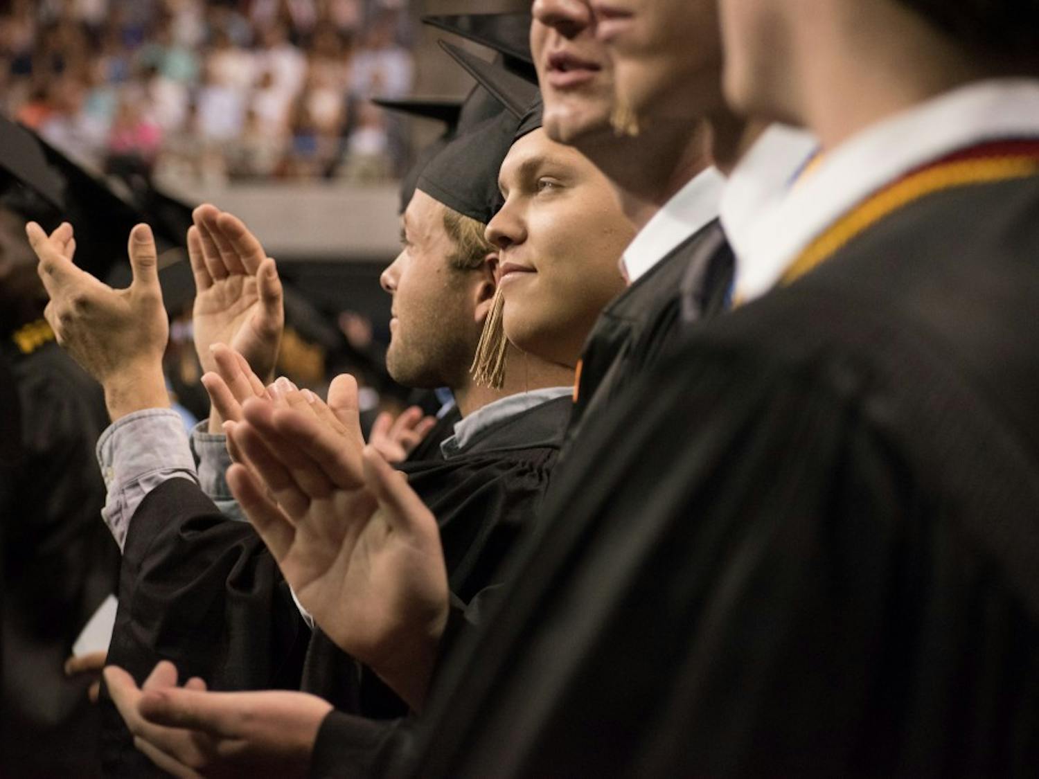 The graduates clap at the graduation ceremony on Sunday, May 6, 2018, in Auburn, Ala.