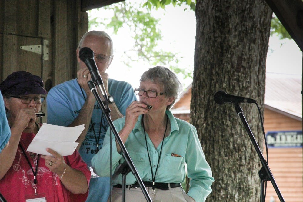 A band showing off their harmonica skills, at the Old-Time Music Festival on Saturday, April 29 in Loachapoka, Ala.