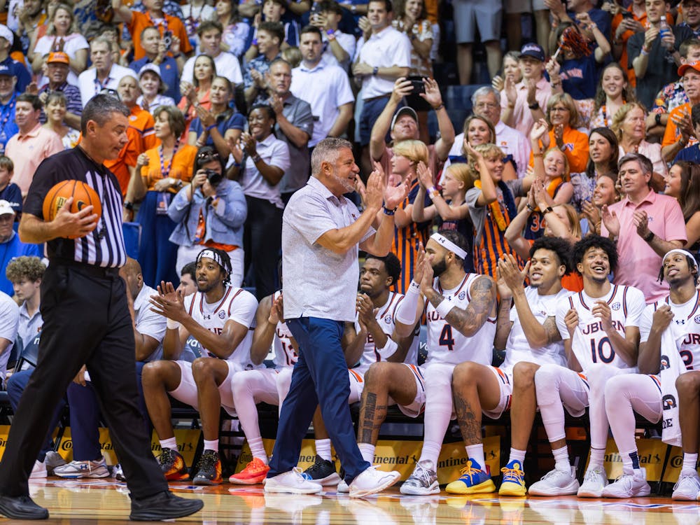 Bruce Pearl and the Auburn bench celebrate with fans moments away from their Maui Invitational championship win on Nov. 27, 2024. 