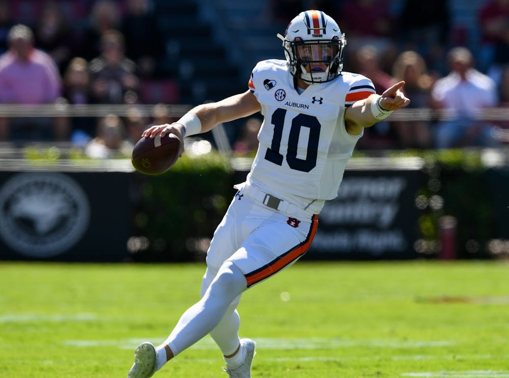 Oct 3, 2020; Columbia, SC, USA; Bo Nix (10) directing blocking while running for the first down during the game between Auburn and South Carolina at Williams-Brice Stadium. Mandatory Credit: Todd Van Emst/AU Athletics
