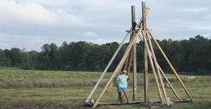 Mark Foshee prepares the trebuchet, or pumpkin launcher, for Thursday's opening. (Melody Kitchens / INTRIGUE EDITOR)