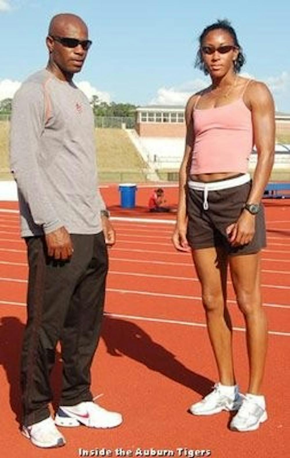 Henry Rolle poses with one of his former Auburn athletes, Markita James, who was on the 2006 Auburn track team. (Courtesy of Inside the Auburn Tigers)