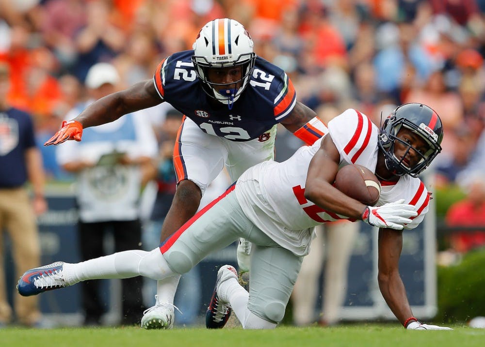 Van Jefferson #12 of the Mississippi Rebels fails to pull in this reception against Jamel Dean #12 of the Auburn Tigers at Jordan Hare Stadium on October 7, 2017 in Auburn, Alabama.
