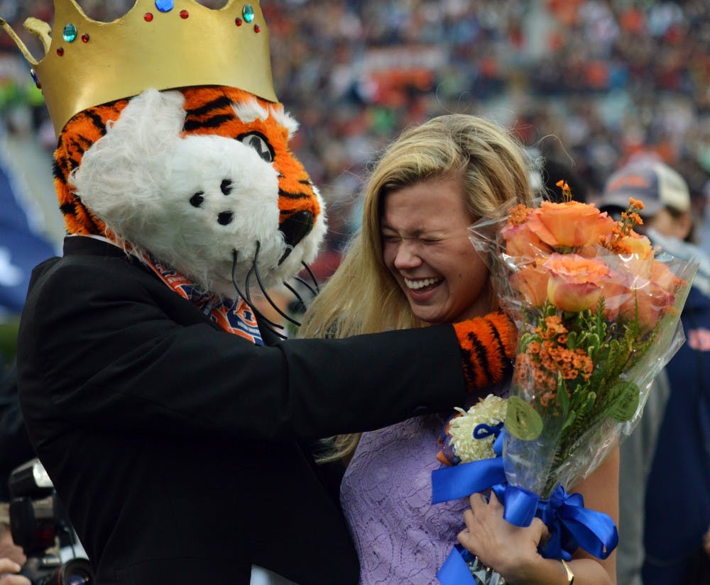 <p>Taylor Wesley hugs Aubie after being named Miss Homecoming. San Jose State at Auburn on Oct. 3.</p>