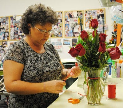 Susan High, Flowersmith's manager,  arranges a bouquet of flowers for a client. (Elaine Busby / Assistant Photo Editor)