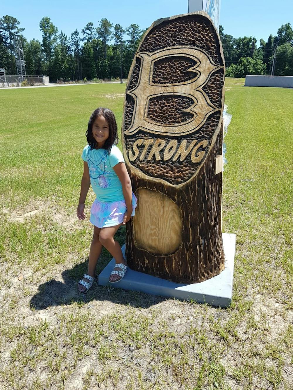 Mattie Ashworth, 7, stands in front of a Beauregard Strong sign. 