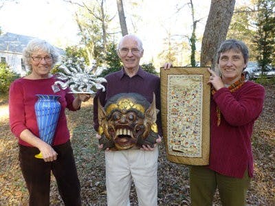 From left to right: Terry Rodriguez, auctioneer; Ken Walters, Auction Chair, and Laura Kloberg, AUUF Aesthetics Chair, display items that will be available for bidding. (Courtesy of AUUF)