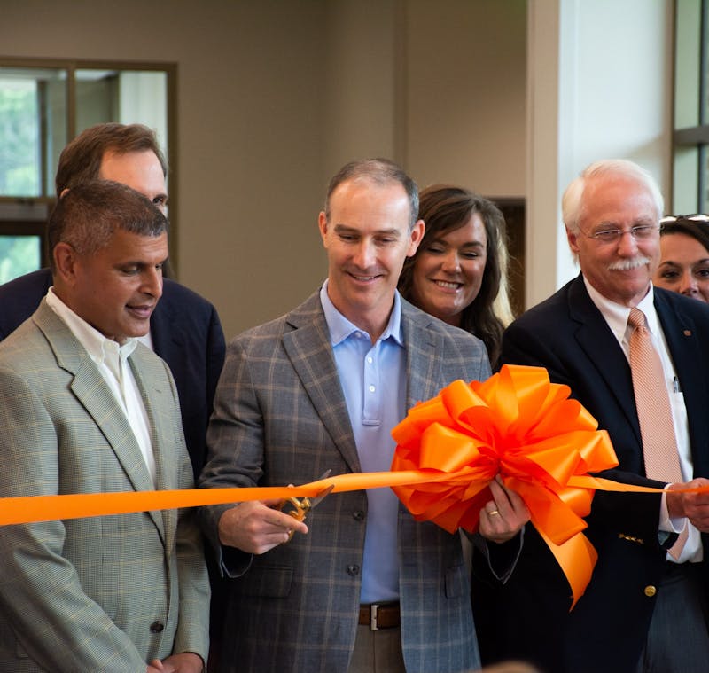 Dr. Trent Wilson, surgeon at The Orthopaedic Clinic, cuts a ribbon to unveil the new Auburn Medical Pavilion on June 4, 2021, in Auburn, Ala.