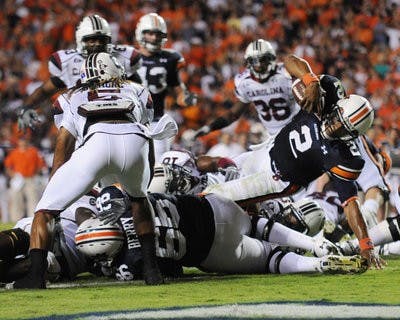 Junior quarterback Cam Newton jumps to a touchdown against South Carolina. Newton now leads the SEC in rushing, averaging 121.3 yards per game. (Christen Harned / Assistant Photo Editor)