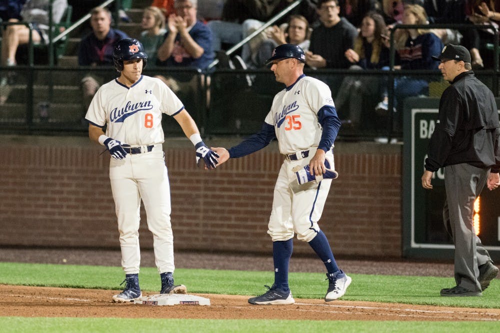 Brendan Venter (8) high-fives coach Karl Nonemaker at first&nbsp;during Auburn baseball vs. Missouri at Plainsman Park in Auburn, Ala. on Friday, March 30, 2018.