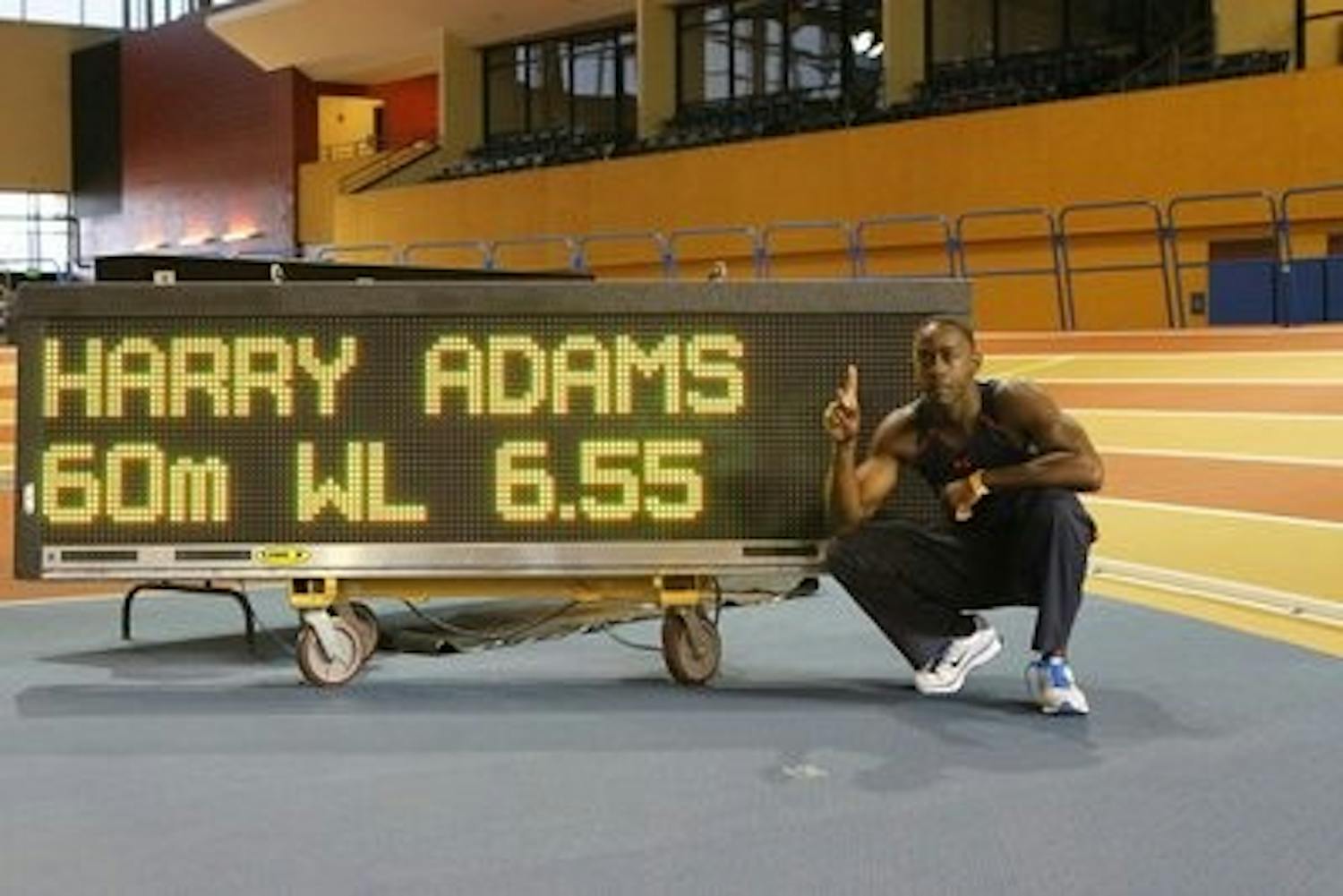 Adams poses beside the scoreboard of his world record run. (CONTRIBUTED)