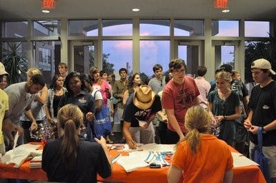 Party-goers sign in at the annual Block Party, which was held in the Student Center Friday. (Christen Harned / ASSISTANT PHOTO EDITOR)
