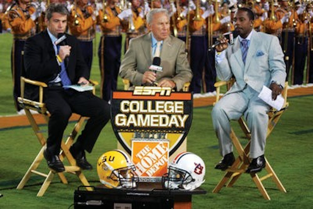 Chris Fowler, Lee Corso and Desmond Howard sit on the sidelines of Jordan-Hare Stadium during the 2008 LSU vs. Auburn game.