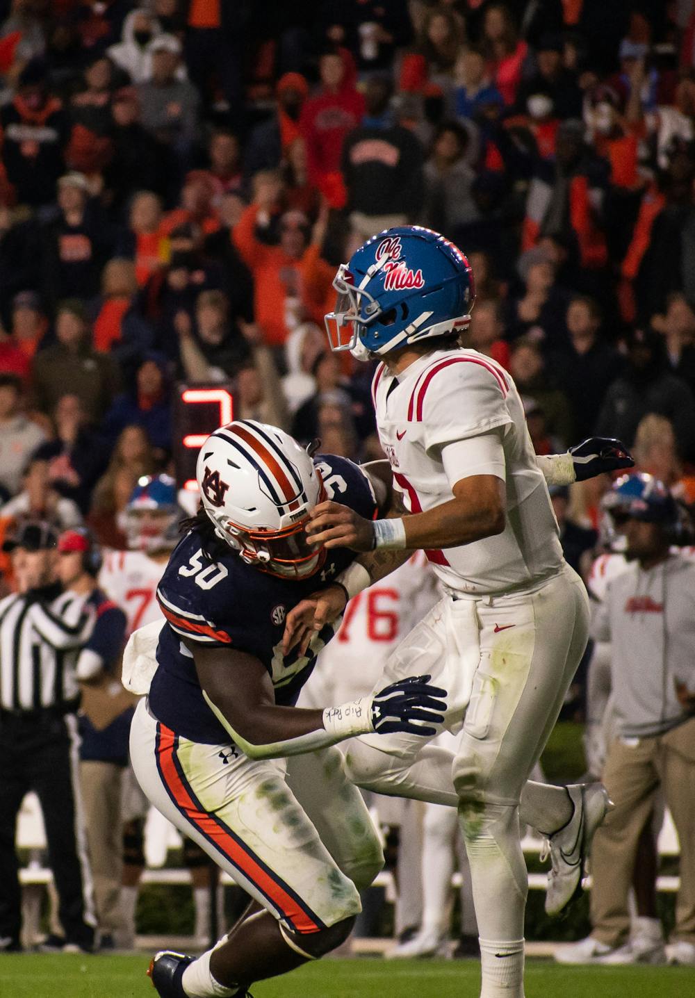 <p>Marcus Harris (50) prepares to tackle Matt Corral (2) during a football game between Ole Miss and Auburn on Oct. 30, 2021, from Jordan-Hare Stadium in Auburn, AL, USA.</p>
